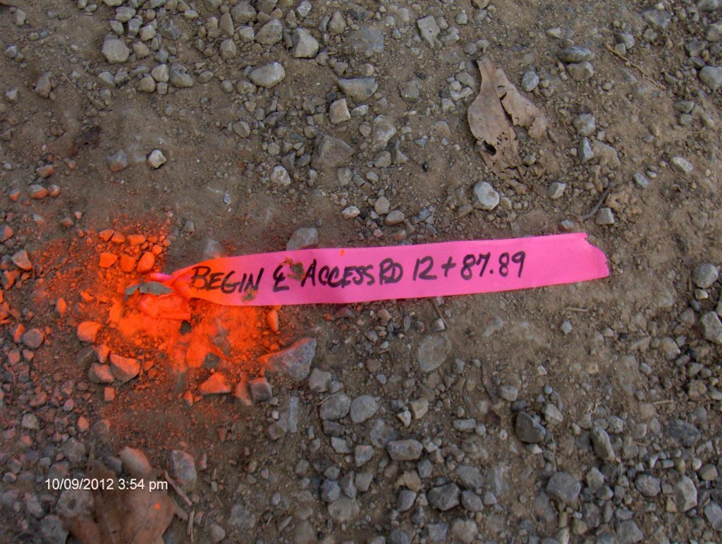 Survey stakes with orange pink ribbons indicating property lines with a  shallow depth of field and copy space Stock Photo